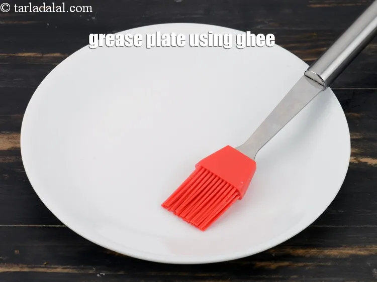 Step 16 – Grease a plate using little ghee.