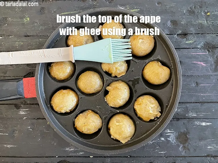 Step 19 – <meta charset="UTF-8" />Then brush the top of the appe with ghee.&nbsp;