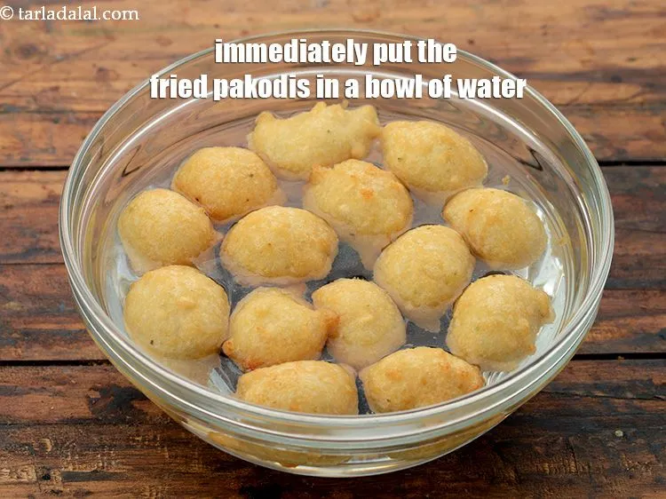 Step 60 – Remember to immediately put the deep fried pakodis immediately in water for soaking. Do not …