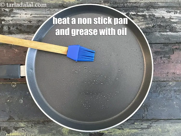 Step 27 – <meta charset="UTF-8" /> Heat a non-stick tava (griddle) on a medium flame and grease it …