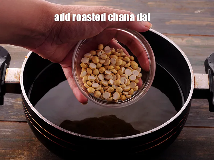 Step 18 – In the same hot oil, add the <a href="https://www.tarladalal.com/glossary-roasted-chana-dal-roasted-daria-286i" target="_blank">roasted chana dal</a>.