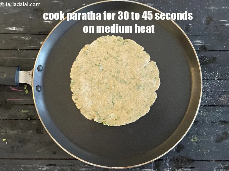 Step 16 – <meta charset="UTF-8" />Cook paratha for 30 to 45 seconds on a medium flame.&nbsp;&nbsp;