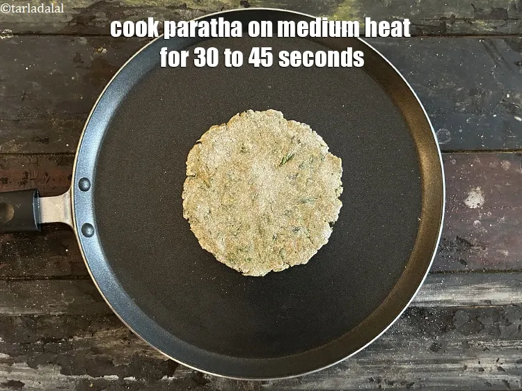 Step 17 – <meta charset="UTF-8" />Cook paratha for 30 to 45 seconds on a medium flame.&nbsp;&nbsp;