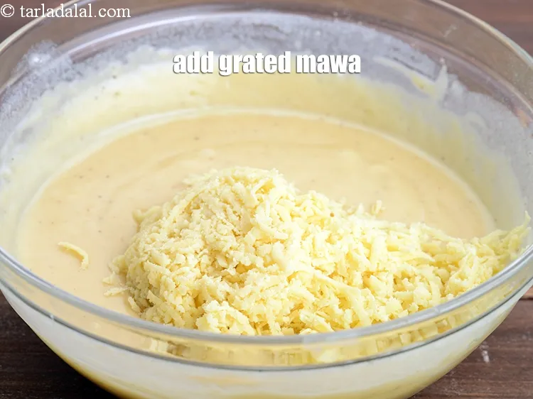 Step 16 – Add &frac12; cup <a href="https://www.tarladalal.com/glossary-grated-mawa-1168i">grated mawa (khoya)</a>.