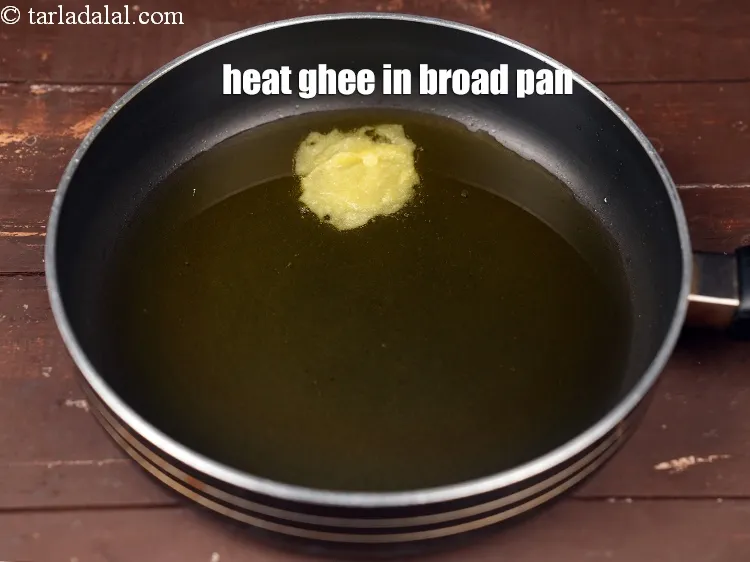 Step 17 – Heat 4 tbsp&nbsp;<a href="https://www.tarladalal.com/glossary-ghee-245i">ghee</a> in a broad non-stick pan.