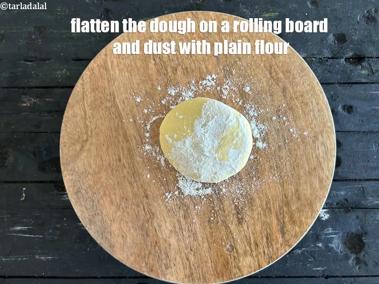 Step 16 – Falatten the dough on a rolling board and dust with flour.