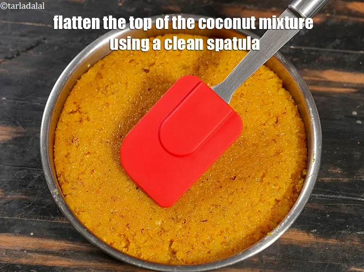 Step 21 – Flatten the top of the coconut mixture using a clean spatula.