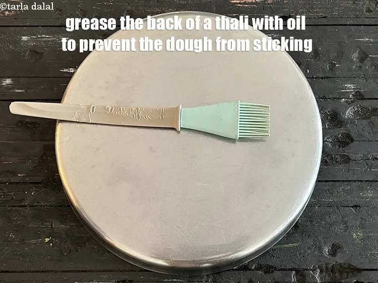 Step 38 – <meta charset="UTF-8" />Grease the back of a steel thali with oil using a brush&nbsp;to prevent …