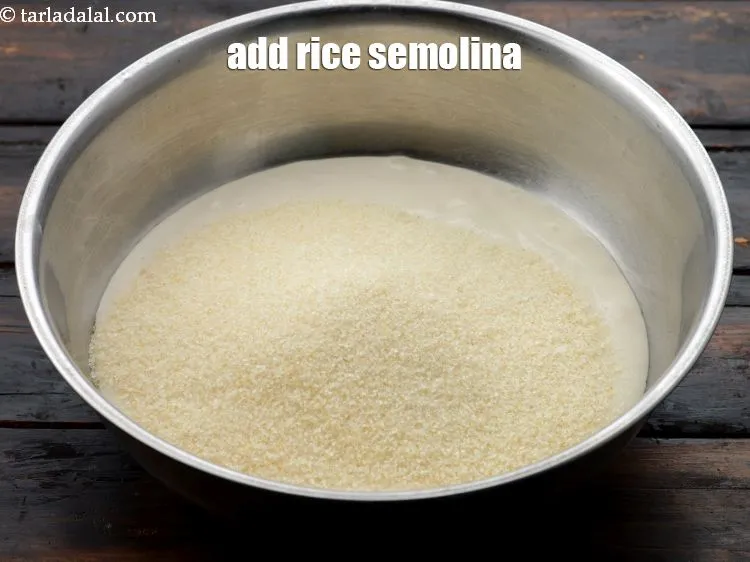 Step 20 – Add&nbsp;1 cup&nbsp;<a href="https://www.tarladalal.com/glossary-rice-semolina-idli-rava-idli-rawa-539i">rice semolina (idli rawa)</a>.&nbsp;