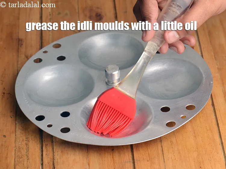 Step 16 – Grease the idli moulds with a little oil.
