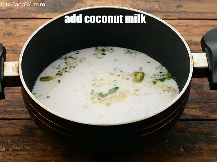 Step 25 – Add the <a href="https://www.tarladalal.com/glossary-coconut-milk-nariyal-ka-doodh-861i" target="_blank">coconut milk</a>.