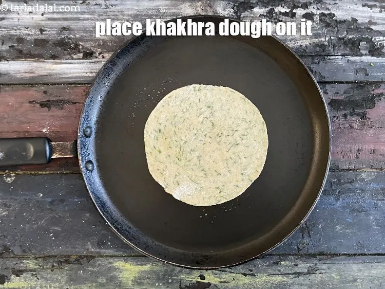 Step 18 – Place the rolled out&nbsp;<strong>Khakhra</strong>&nbsp;dough on it.&nbsp;