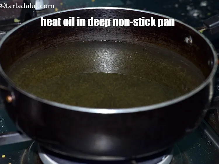 Step 16 – Heat <a href="https://www.tarladalal.com/glossary-oil-671i">oil</a>&nbsp;for deep-frying in a deep non-stick pan.
