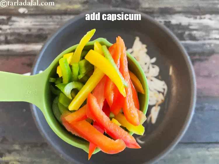 Step 16 – Add&nbsp;<meta charset="UTF-8" />1&nbsp;cup&nbsp;thinly&nbsp;<a href="glossary-sliced-capsicum-165i">sliced capsicum</a>. Use a combination of green, red and yellow capsicum.