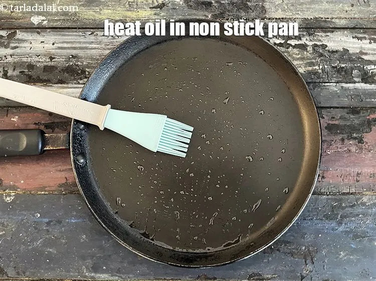 Step 38 – Heat a non-stick tava (griddle) and grease it with oil.