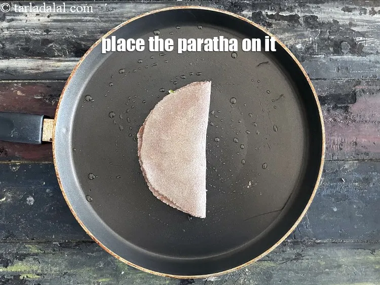 Step 21 – Place the paratha on it.