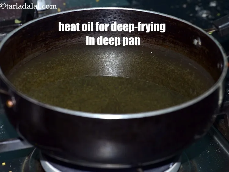 Step 16 – Heat <a href="https://tarladalal.com/glossary-oil-671i">oil</a>&nbsp;for deep-frying in a deep non-stick pan.