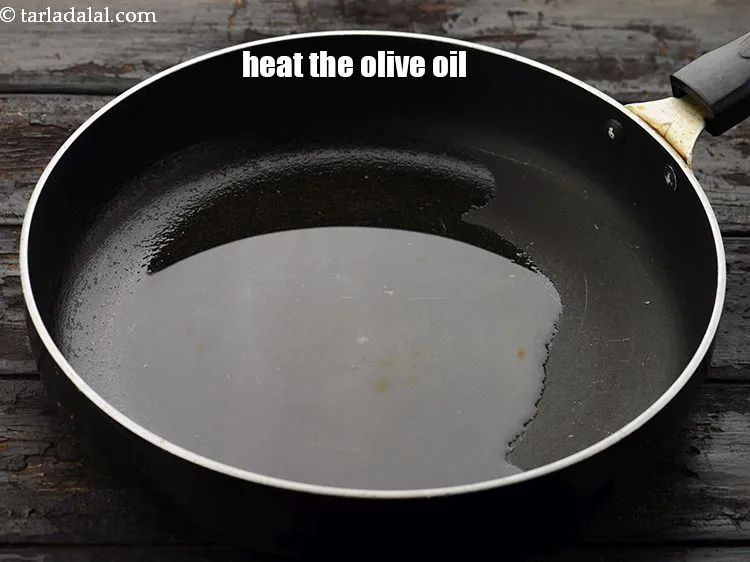 Step 16 – To make<strong> tomato basil sauce</strong>, heat 2 tbsp&nbsp;<a href="https://www.tarladalal.com/glossary-olive-oil-451i">olive oil</a>&nbsp;in a broad non-stick pan.