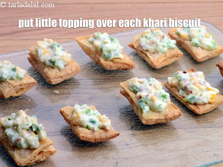 Step 16 – Put a little topping over each khari biscuit.