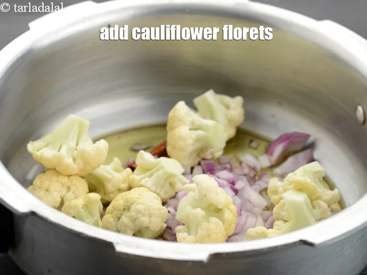 Step 21 – Add 3/4 cup&nbsp;<a href="https://www.tarladalal.com/glossary-cauliflower-florets-753i">cauliflower florets</a>.