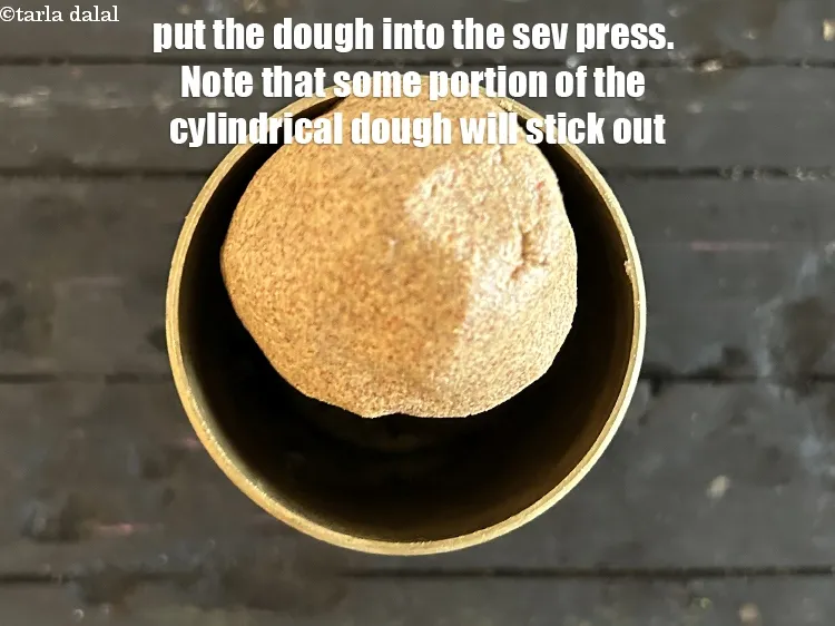 Step 18 – Put the dough into the &ldquo;sev press&rdquo;. Note that some portion of the cylindrical dough …