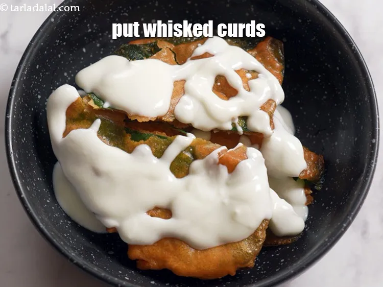 Step 16 – Put &frac14; cup of <a href="https://tarladalal.com/glossary-whisked-curds--2096i">whisked curds (dahi)</a>.