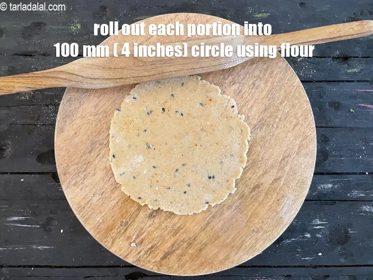 Step 16 – Roll out each portion into a 100 mm. (4") diameter thin circle, using a little …