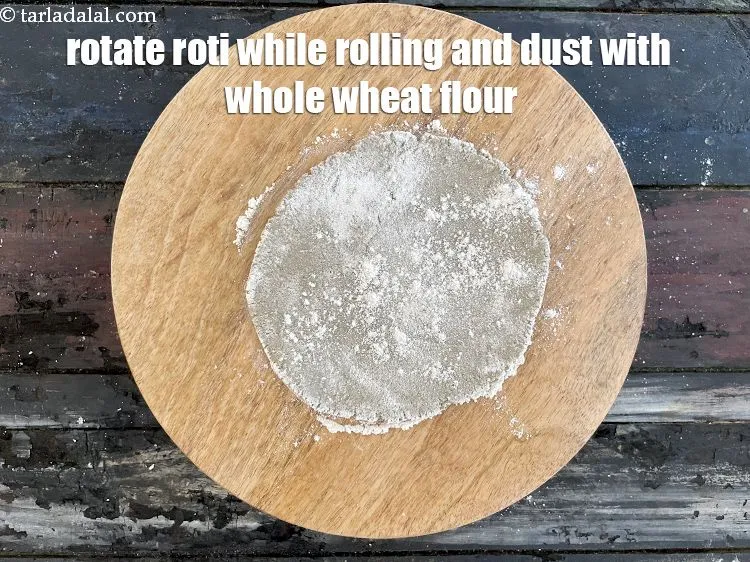 Step 19 – Keep rotating the roti while rolling and dust with whole wheat flour.