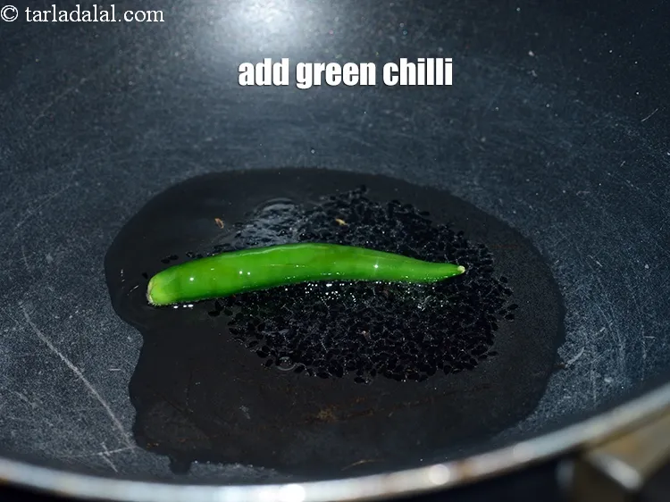 Step 17 – Add 1 slit <a href="https://www.tarladalal.com/glossary-green-chillies-hari-mirch-331i">green chilli</a>&nbsp;.&nbsp;
