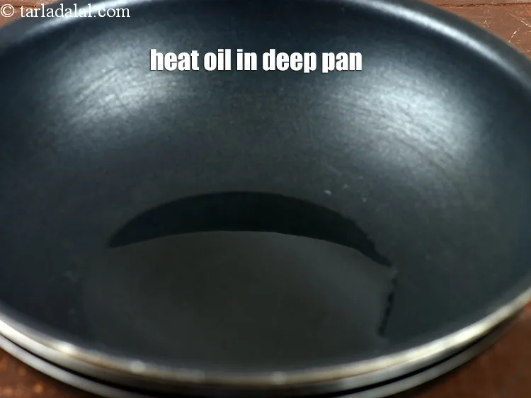 Step 16 – Heat 3 tbsp <a href="https://www.tarladalal.com/glossary-oil-671i">oil</a> in a deep pan.