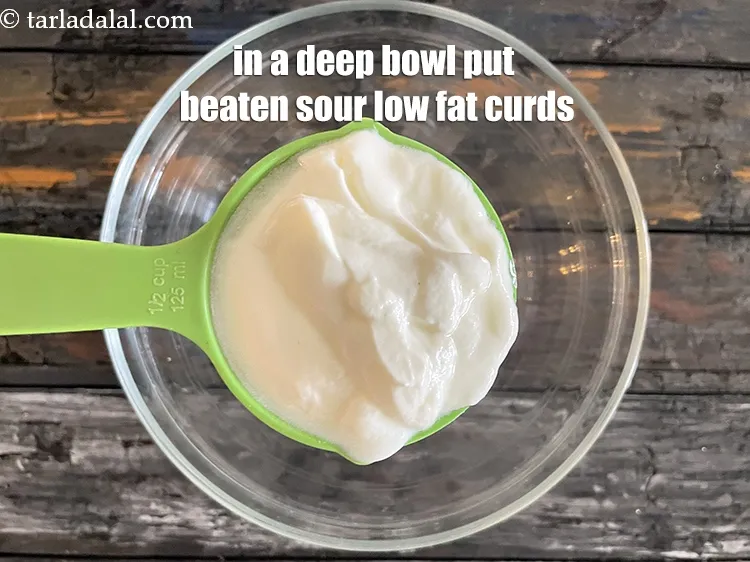 Step 16 – In a deep bowl put&nbsp;<meta charset="UTF-8" />1/2 cup&nbsp;beaten&nbsp;<a href="glossary-sour-low-fat-curds-khatta-low-fat-dahi-2463i">sour low-fat curds (dahi)</a>.
