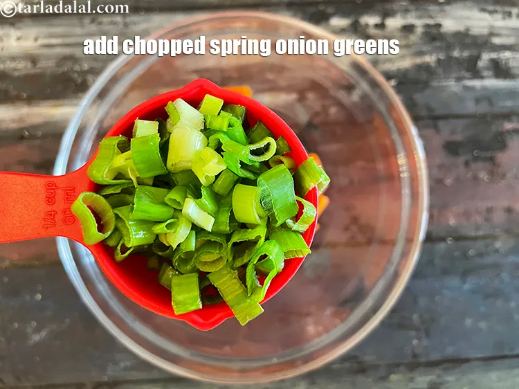 Step 22 – Add&nbsp;<meta charset="UTF-8" />1/2 cup&nbsp;roughly&nbsp;<a href="glossary-chopped-spring-onion-greens-1030i">chopped spring onion greens</a>.