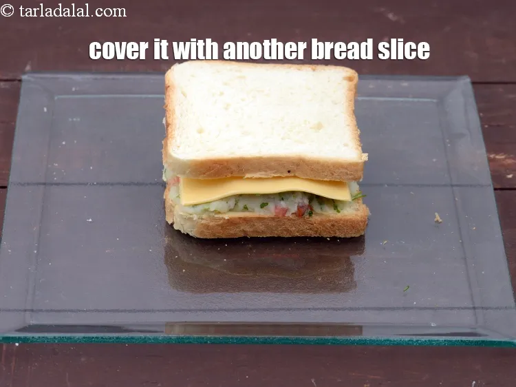 Step 16 – Cover it with another bread slice with the buttered side facing downwards.