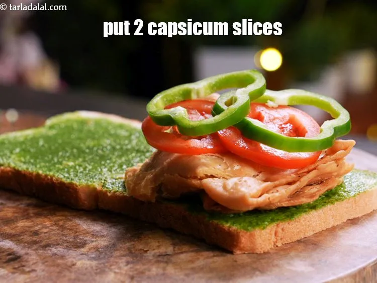 Step 18 – Arrange 2 <a href="https://www.tarladalal.com/glossary-capsicum-rings-167i">capsicum slices</a>.&nbsp;