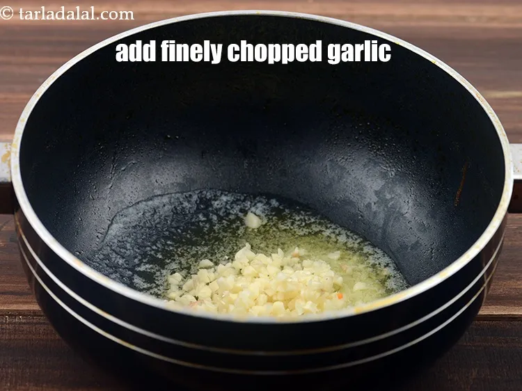 Step 16 – Add 1&frac12; tbsp finely <a href="https://www.tarladalal.com/glossary-chopped-garlic-790i">chopped garlic (lehsun)</a>.