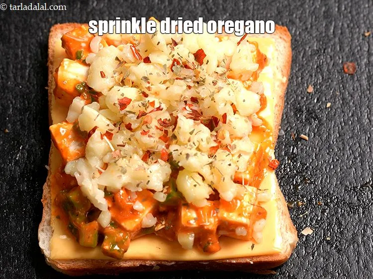 Step 16 – Sprinkle &frac14; tsp <a href="https://www.tarladalal.com/glossary-dried-oregano-268i">dried oregano</a>.