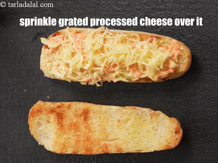 Step 16 – Sprinkle 1 tbsp&nbsp;<a href="https://tarladalal.com/glossary-grated-processed-cheese-868i">grated processed cheese</a> over it.