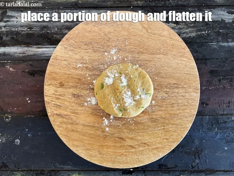 Step 16 – Place a portion of the dough on it and flatten it.