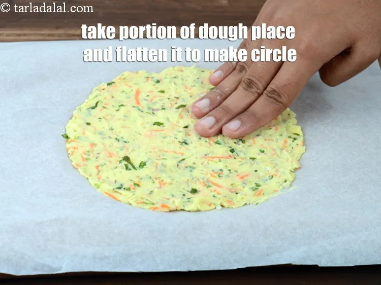 Step 15 – Take a portion of the dough place on the butter paper and flatten it with …