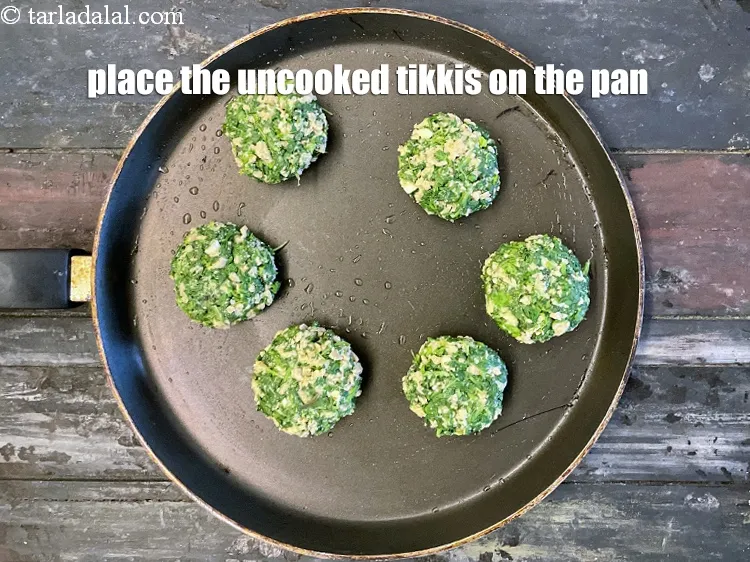 Step 32 – Place the uncooked <strong>soya vegetable tikki</strong>s on the tava.