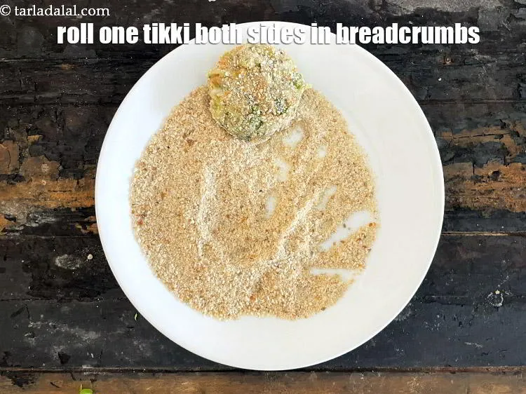 Step 21 – <meta charset="UTF-8" /> Roll one tikki in a plate of breadcrumbs. You will need to …