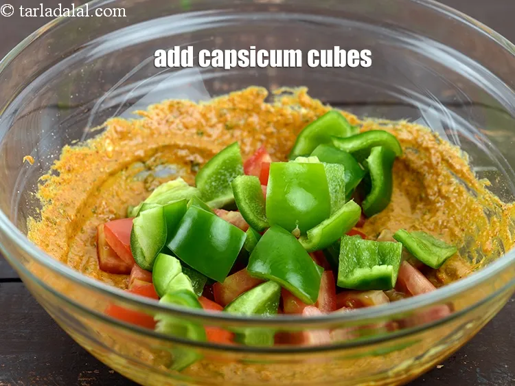 Step 17 – Add &frac12; cup <a href="https://www.tarladalal.com/glossary-capsicum-cubes-170i">capsicum cubes</a>.