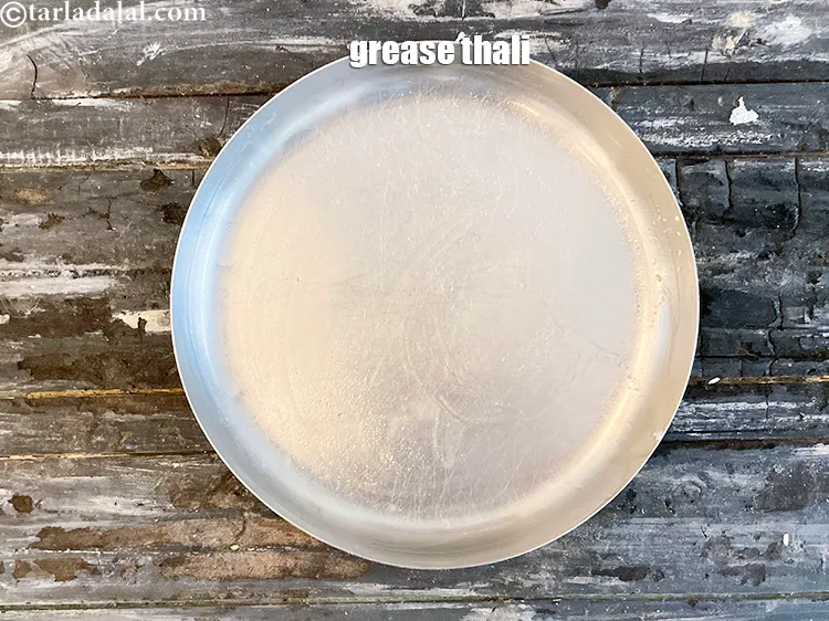 Step 27 – Grease a 6 inch thali with ghee.