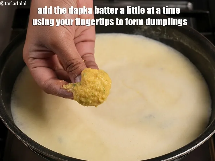 Step 19 – Add the dapka batter a little at a time using your fingertips to form dumplings.