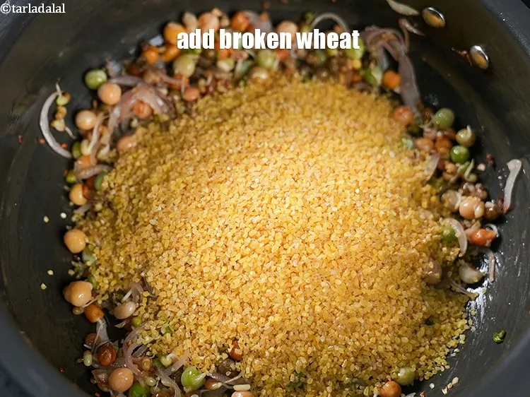 Step 17 – Add 1 cup <a href="https://www.tarladalal.com/glossary-broken-wheat-dalia-bulgur-wheat-lapsi-fada-426i">broken wheat (dalia)</a>.&nbsp;