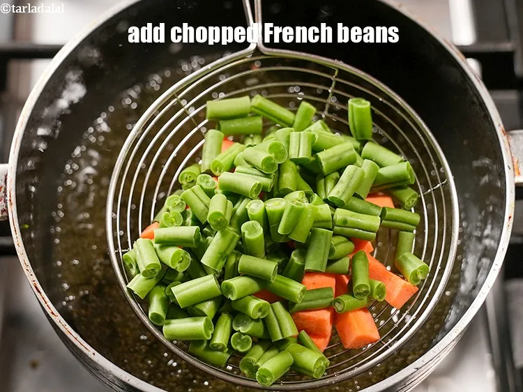 Step 18 – Add &frac12; cup <a href="https://www.tarladalal.com/glossary-chopped-french-beans-797i">chopped french beans</a>.