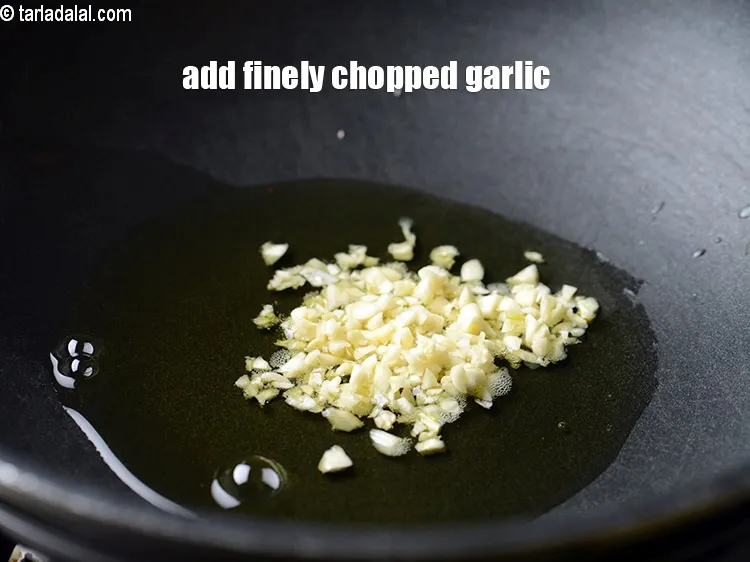 Step 18 – Add 2 tsp finely <a href="https://www.tarladalal.com/glossary-chopped-garlic-790i">chopped garlic (lehsun)</a>.