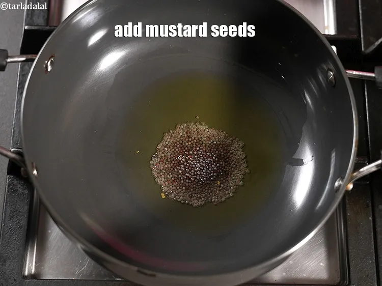 Step 17 – Add 1 tsp&nbsp;<a href="https://www.tarladalal.com/glossary-mustard-seeds-sarson-rai-sarson-ke-beej-525i">mustard seeds ( rai / sarson)</a>.