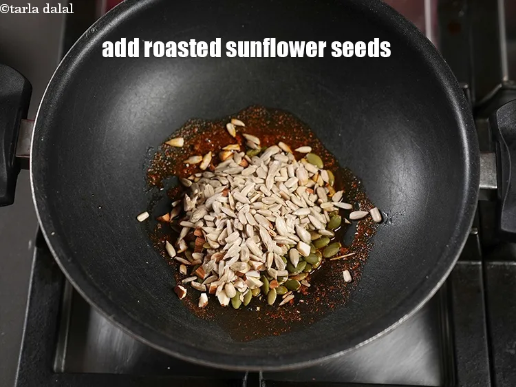 Step 17 – Add 2 tbsp <a href="https://www.tarladalal.com/glossary-roasted-sunflower-seeds-2535i">roasted sunflower seeds (surajmukhi ke beej)</a>.