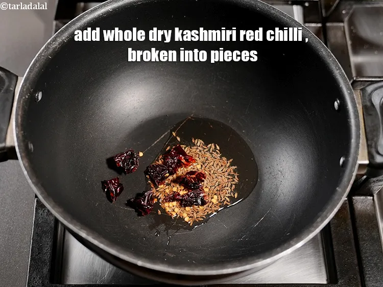 Step 17 – Add 1 <a href="https://www.tarladalal.com/glossary-whole-dry-kashmiri-red-chillies-kashmiri-mirch-kashmiri-lal-mirch-332i">whole dry kashmiri red chilli</a>&nbsp;, broken into pieces.